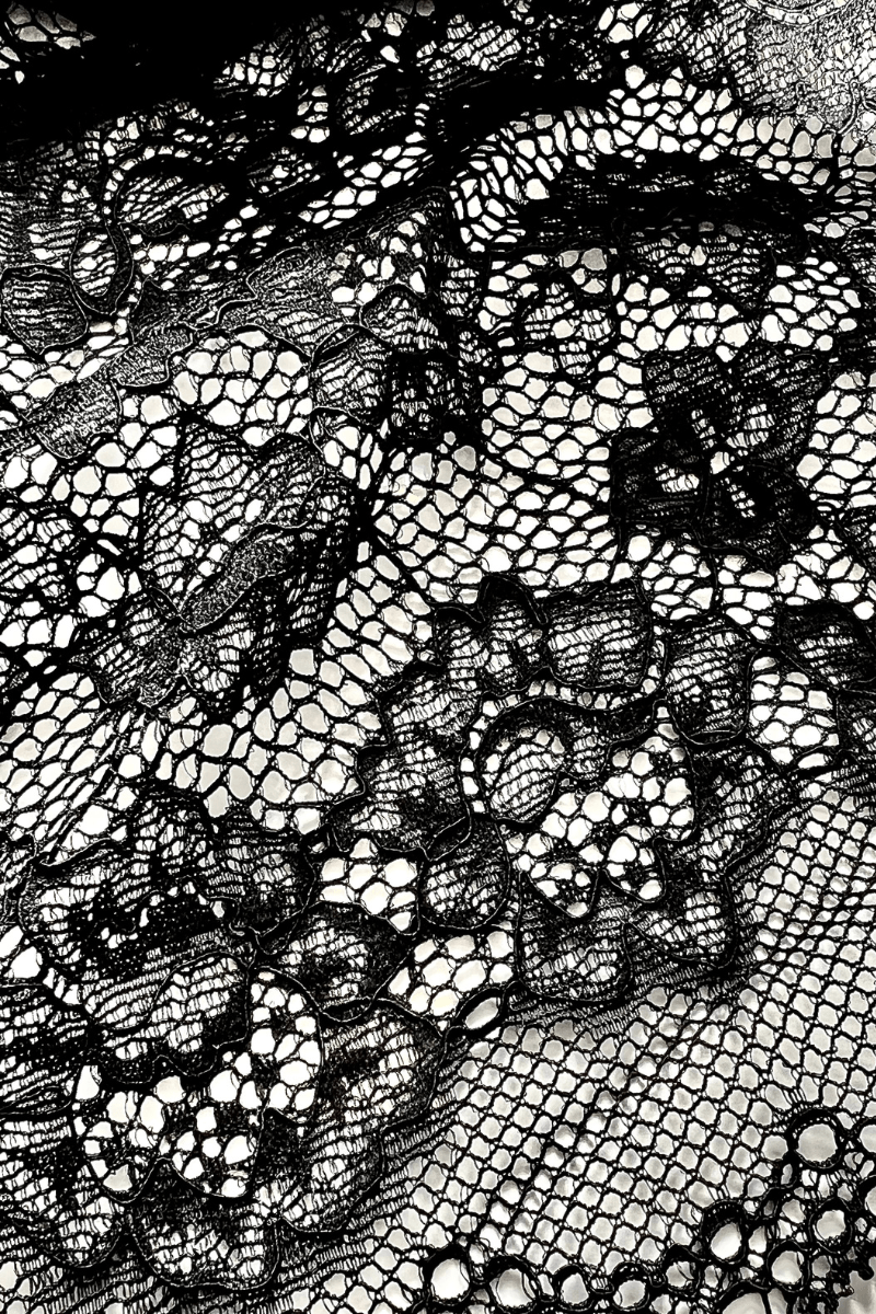 Close up of black stretch lace fabric used in Ender Legard backless bodysuits