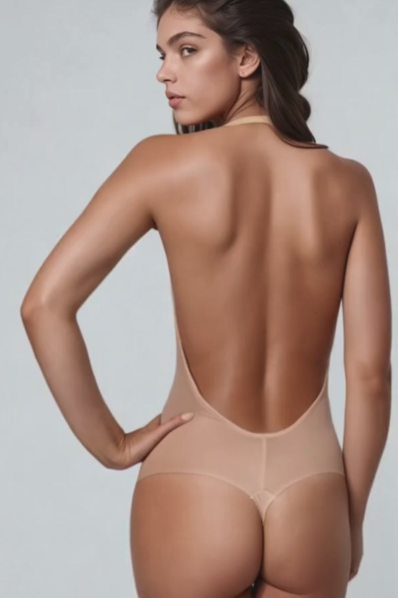 Video of a model wearing an Ender Legard LEXI backless bodysuit in colour beige as seen from the back as she walks away from the camera